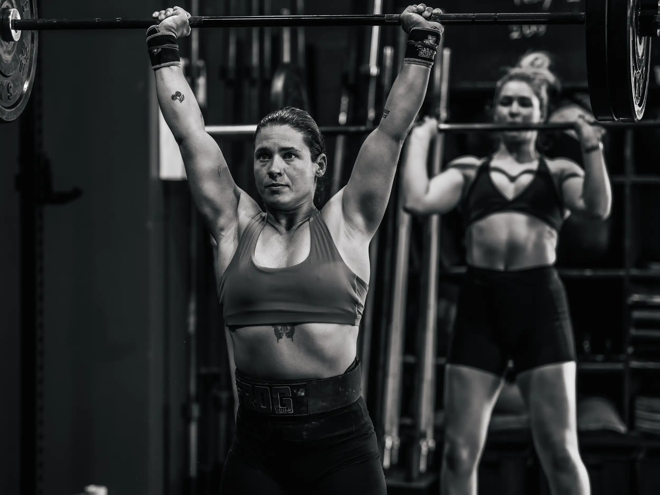 Athletes performing a barbell movement during a CrossFit class