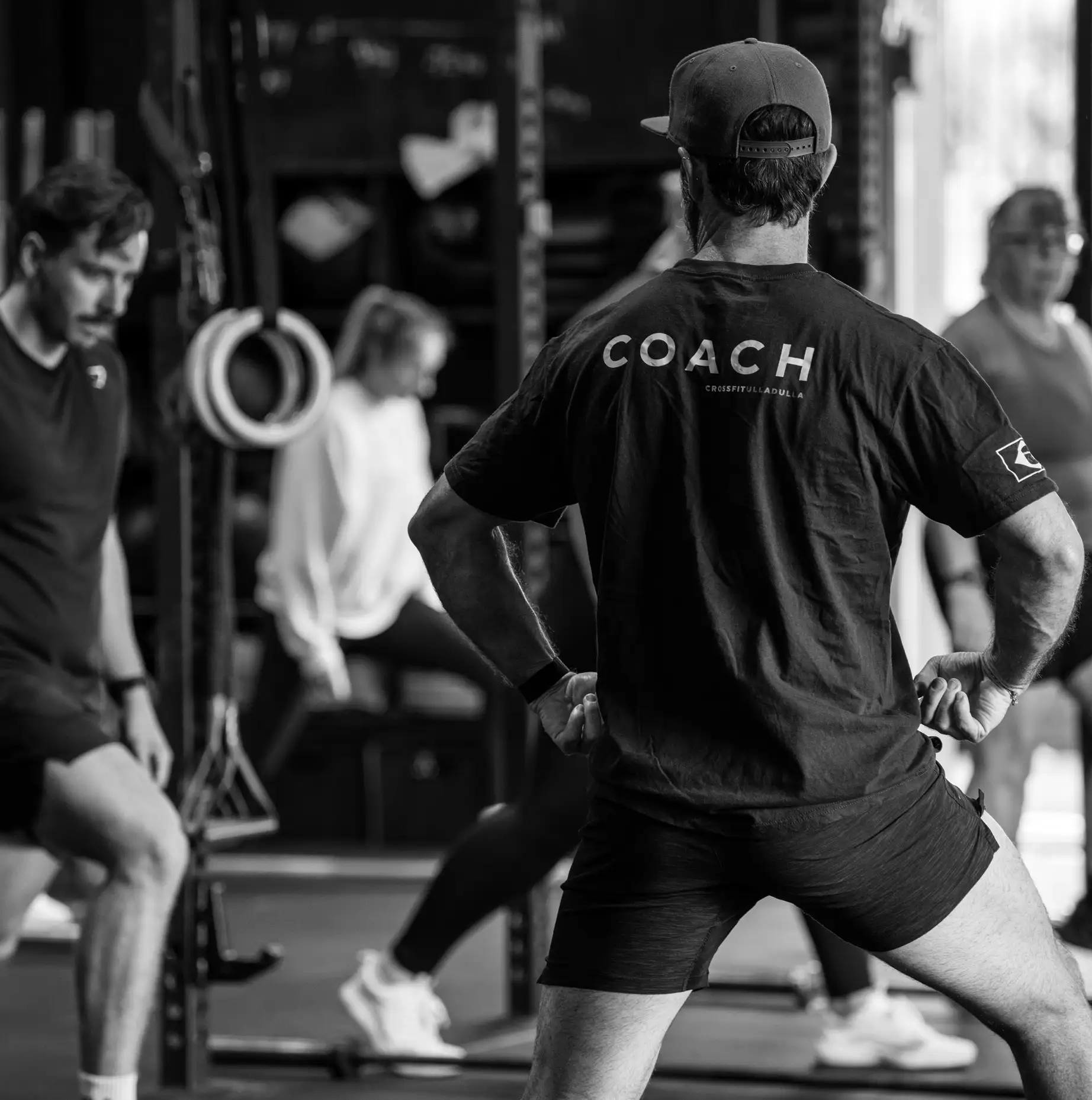 A CrossFit Ulladulla coach demonstrating a movement to a group