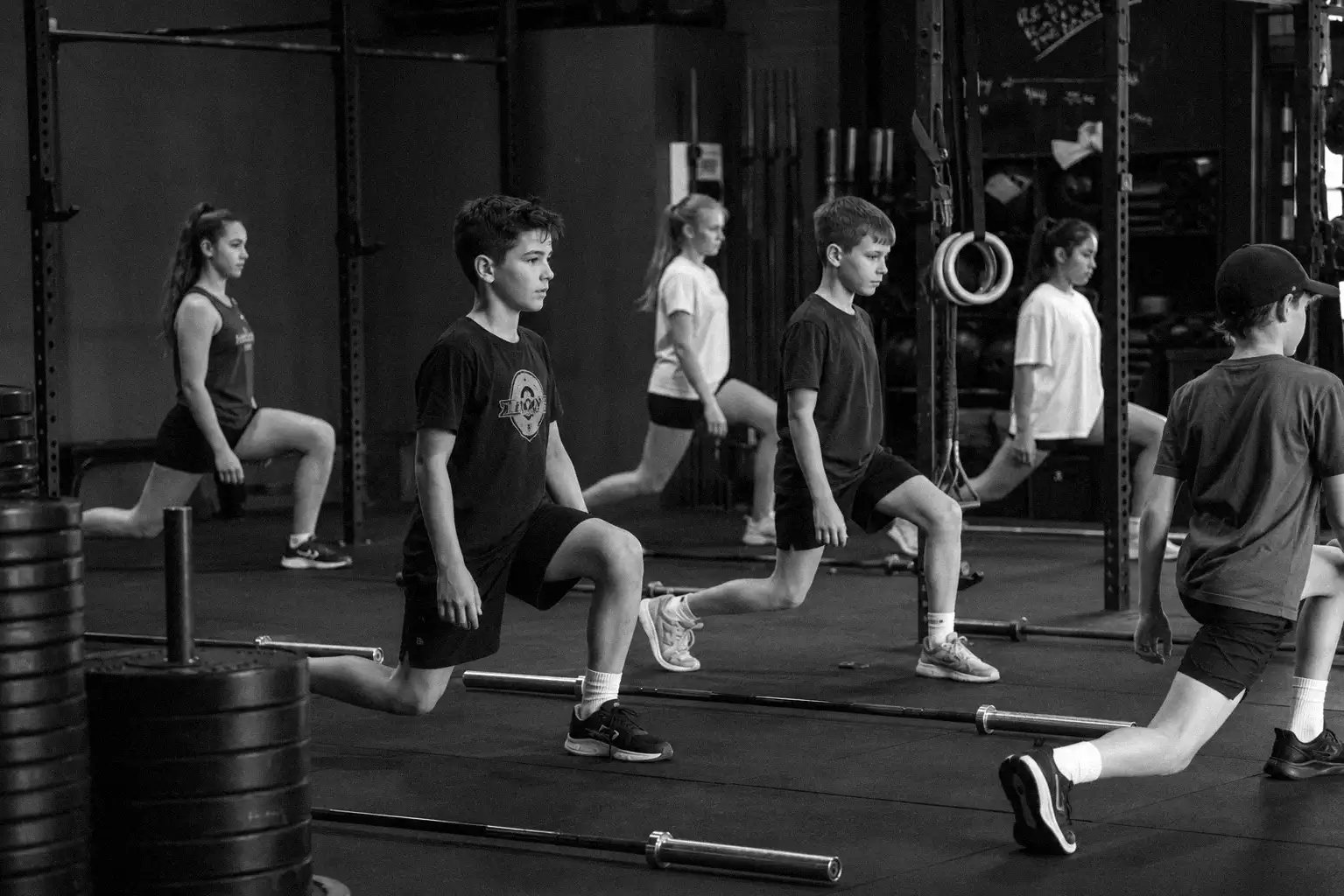 Young athletes smiling and high-fiving after a class
