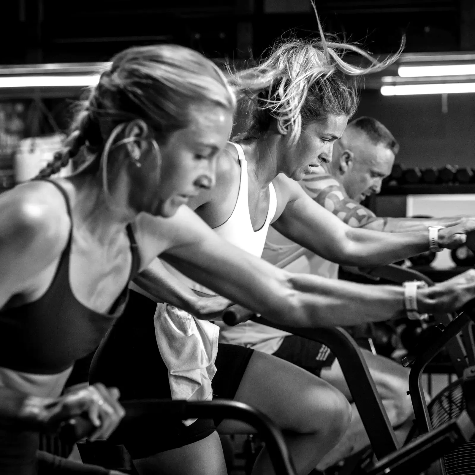 CrossFit Ulladulla members working side by side on air bikes